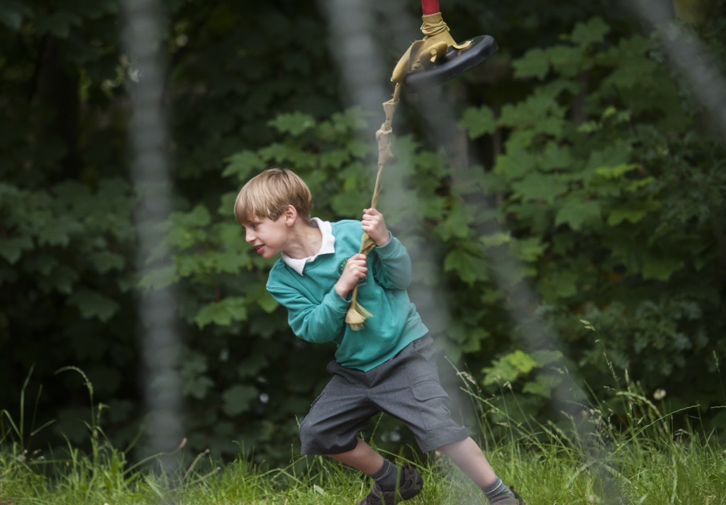 Boy pulling zip wire along