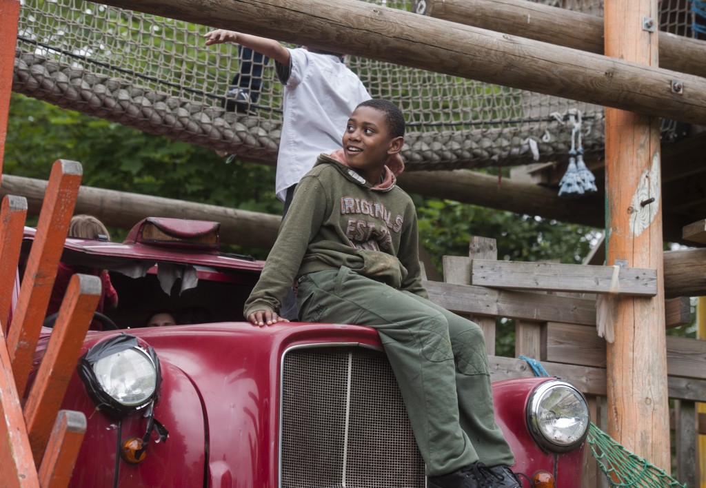 Boy sits astride 'floating' London taxi in adventure playground